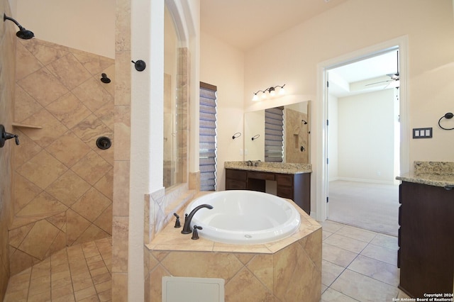 bathroom featuring a garden tub, tile patterned flooring, a tile shower, and vanity