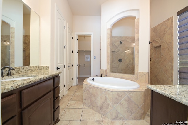 bathroom featuring tile patterned flooring, vanity, and separate shower and tub