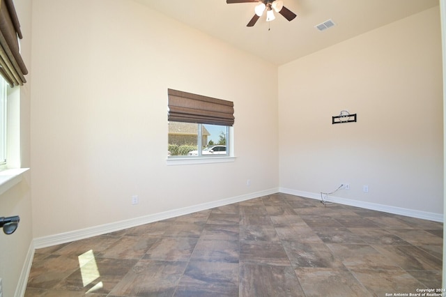 unfurnished room with visible vents, ceiling fan, and baseboards