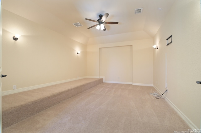 carpeted empty room with ceiling fan and vaulted ceiling