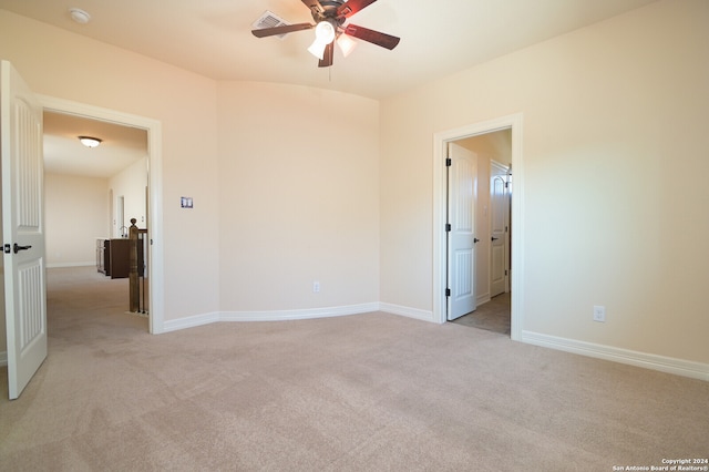 spare room featuring ceiling fan and light colored carpet