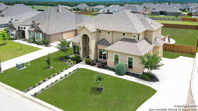 view of front of home featuring a residential view, fence, and a front yard