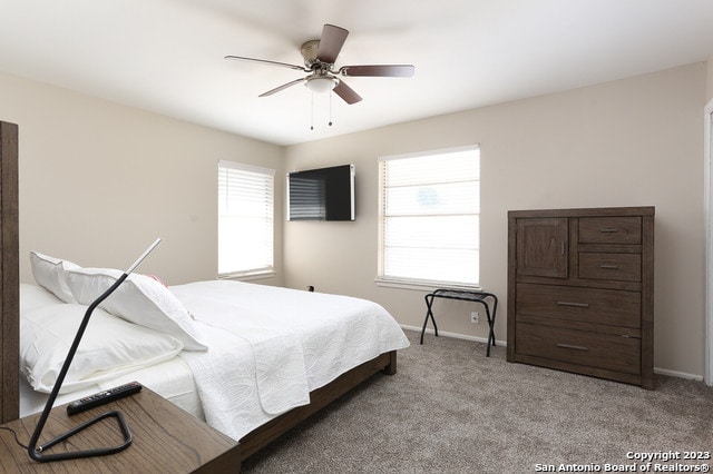 bedroom with light colored carpet and ceiling fan