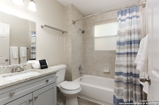 full bathroom with vanity, toilet, and shower / tub combo with curtain