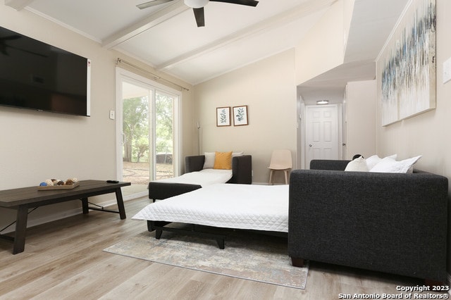 bedroom featuring ceiling fan, access to outside, vaulted ceiling with beams, and light hardwood / wood-style floors