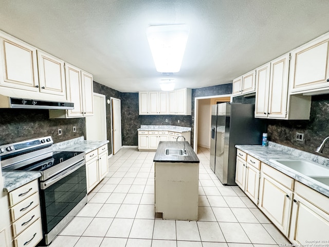 kitchen featuring a kitchen island, stainless steel appliances, light tile patterned flooring, and sink