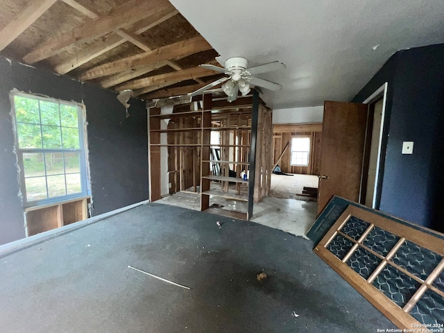 interior space with lofted ceiling and ceiling fan