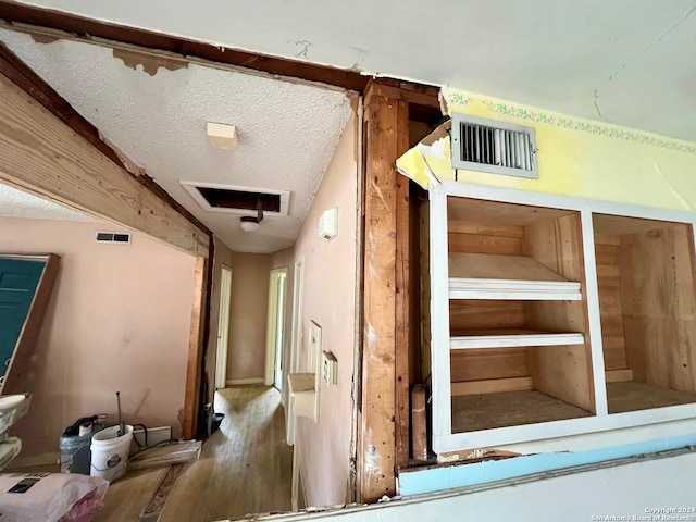 interior space with a textured ceiling and hardwood / wood-style flooring