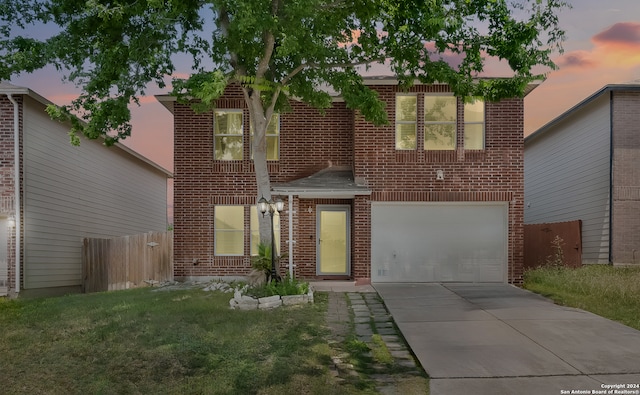 view of front of house with a yard and a garage