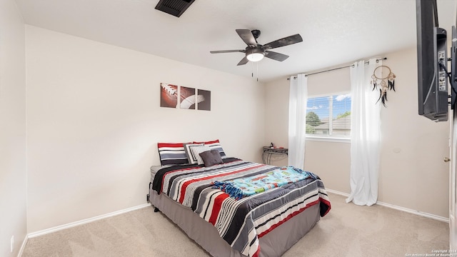 carpeted bedroom with visible vents, ceiling fan, and baseboards