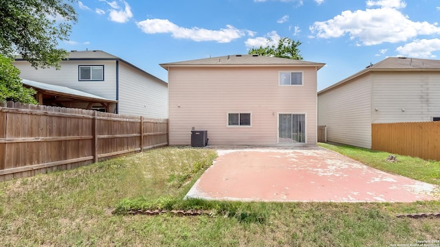 back of property featuring a yard, a patio, central AC unit, and fence