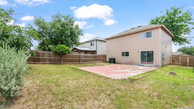 back of house featuring a patio area, a yard, and central air condition unit