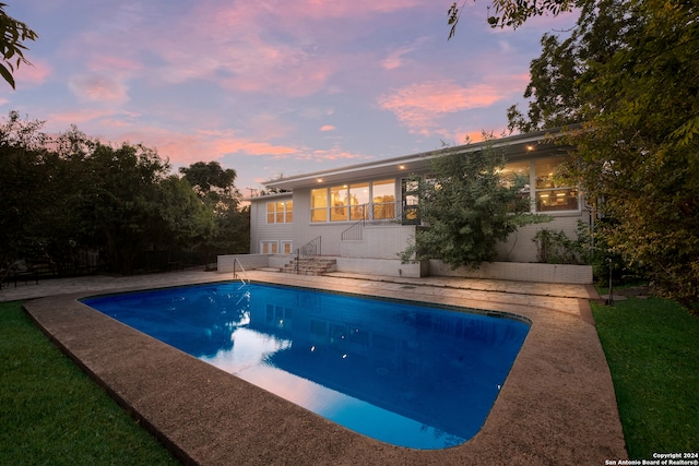 view of pool at dusk