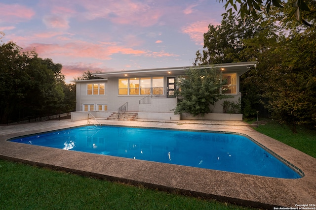 view of pool at dusk