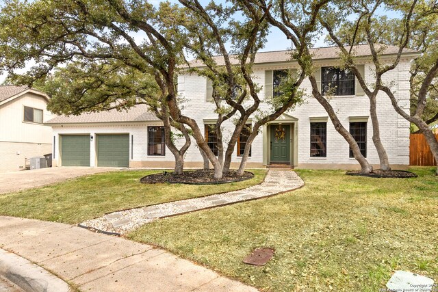 view of front of property with a garage and a front lawn