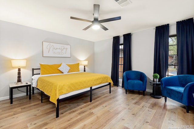 bedroom with light hardwood / wood-style flooring and ceiling fan