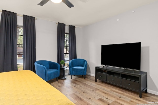 bedroom featuring light hardwood / wood-style flooring, multiple windows, and ceiling fan