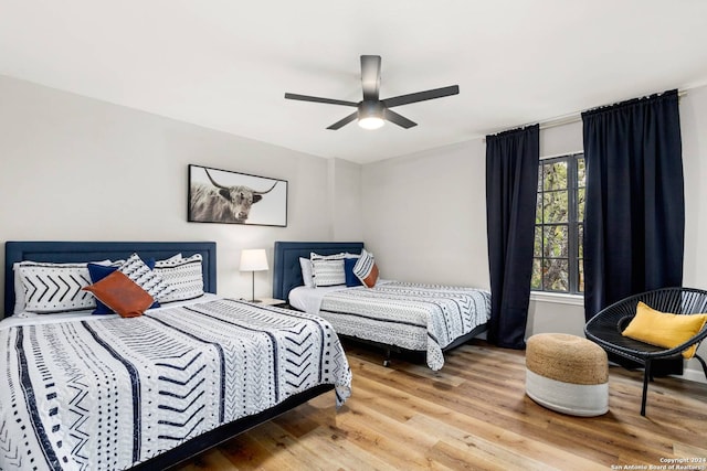 bedroom with hardwood / wood-style flooring and ceiling fan