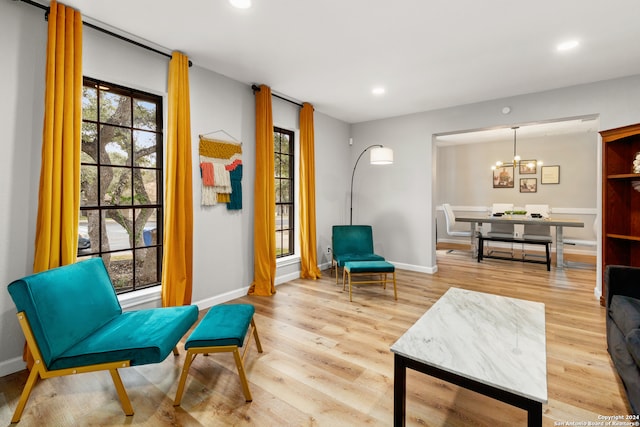 sitting room with a notable chandelier and light hardwood / wood-style floors