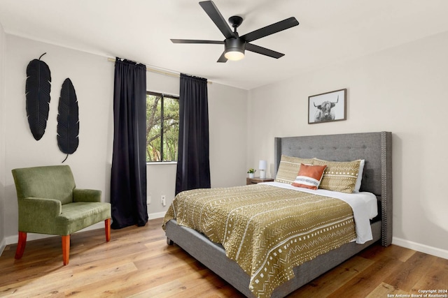 bedroom featuring light hardwood / wood-style floors and ceiling fan