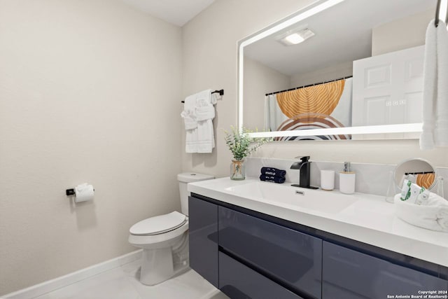 bathroom featuring vanity, tile patterned flooring, and toilet