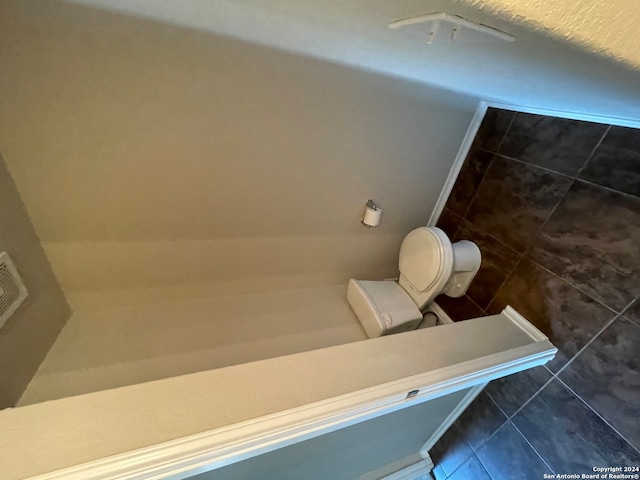 bathroom featuring toilet and tile patterned floors