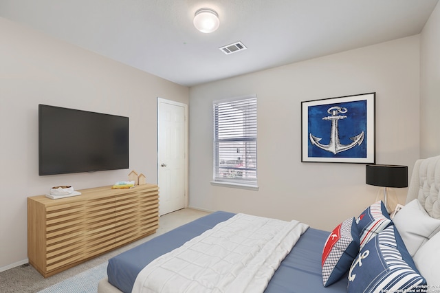 bedroom featuring light colored carpet