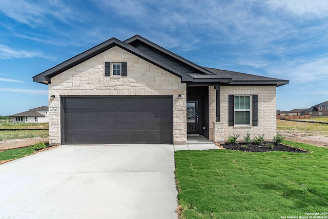 view of front of house with a garage and a front yard