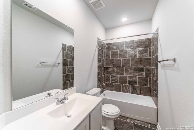 full bathroom with tile patterned floors, toilet, tiled shower / bath combo, and vanity