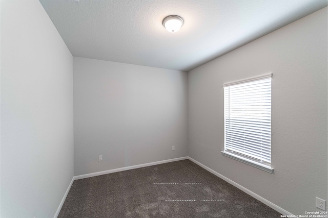 unfurnished room featuring a textured ceiling and carpet floors