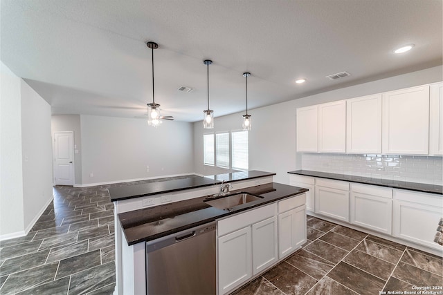 kitchen featuring dishwasher, white cabinetry, sink, ceiling fan, and a kitchen island with sink