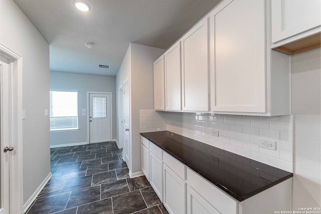 kitchen with white cabinets and decorative backsplash