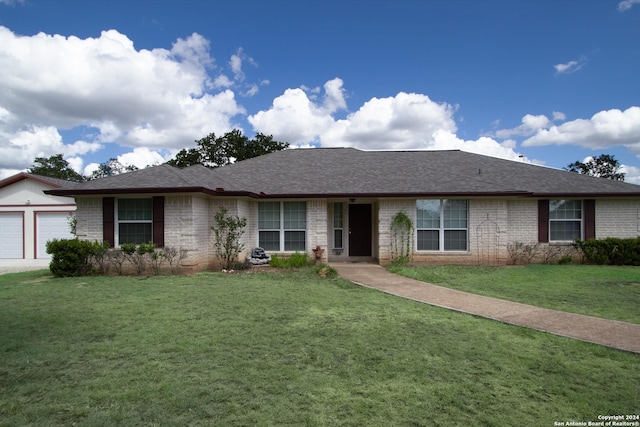 single story home with a garage and a front yard