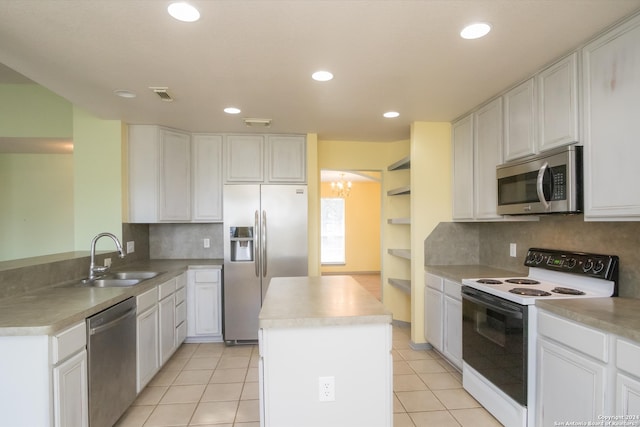 kitchen with a center island, backsplash, sink, and appliances with stainless steel finishes