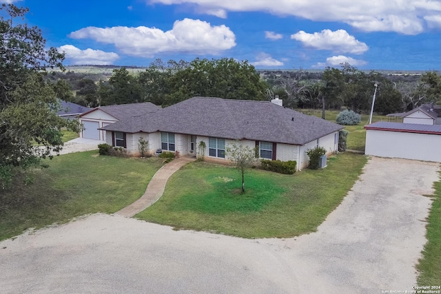 ranch-style home featuring a garage and a front lawn