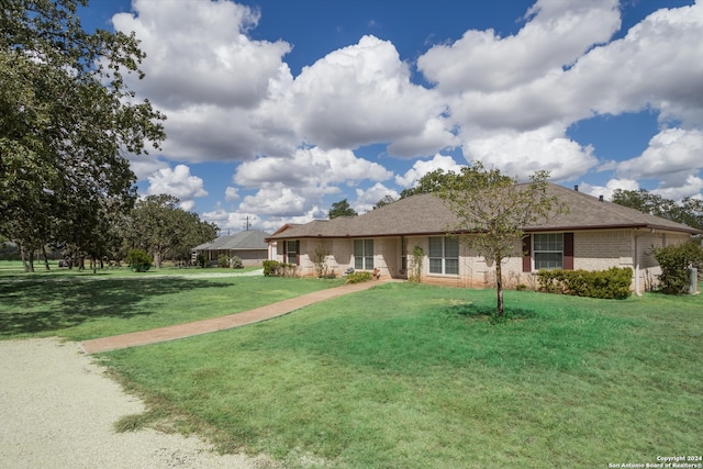 ranch-style home with a front lawn