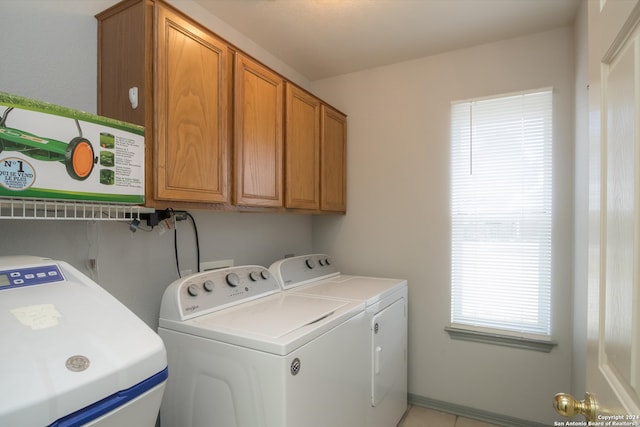 laundry room featuring cabinets and washer and clothes dryer