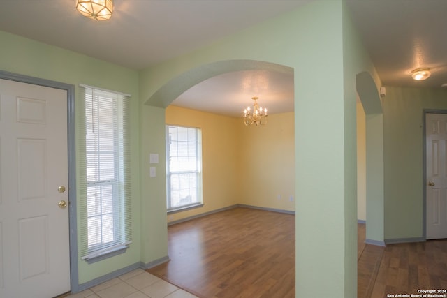 entryway with hardwood / wood-style flooring and an inviting chandelier