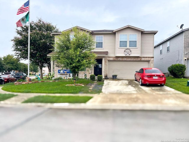 view of front of home with a garage and a front lawn