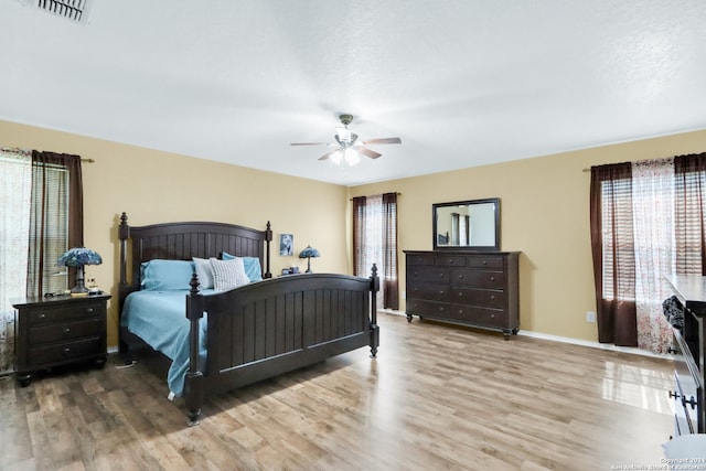 bedroom with ceiling fan and hardwood / wood-style flooring