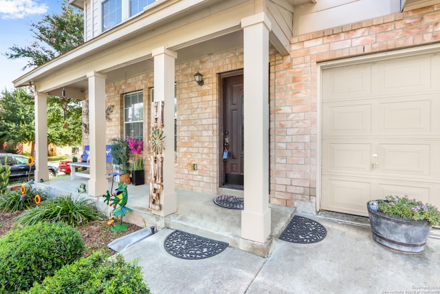 entrance to property with a garage and covered porch