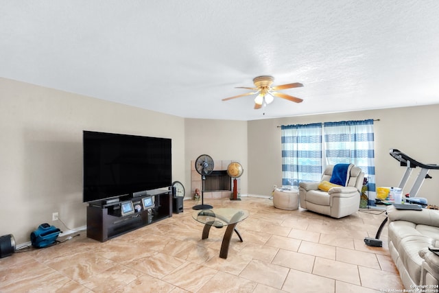 living room featuring a textured ceiling and ceiling fan