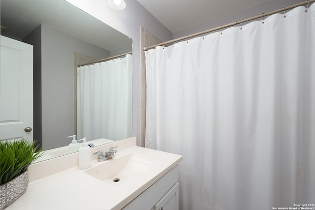 bathroom with vanity and curtained shower