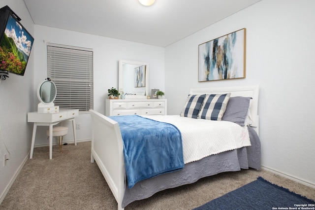 carpeted bedroom featuring baseboards