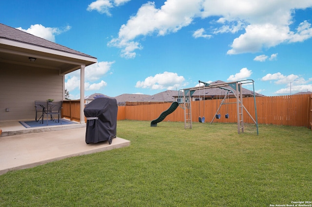 view of yard featuring a patio and a playground