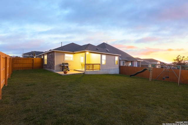 back of house featuring a patio area, a fenced backyard, and a yard