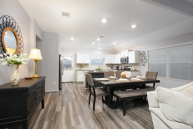 dining room with light wood-type flooring, visible vents, and recessed lighting