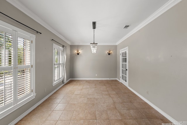 tiled empty room featuring ornamental molding and a chandelier