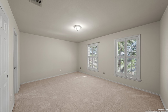 unfurnished bedroom with light colored carpet