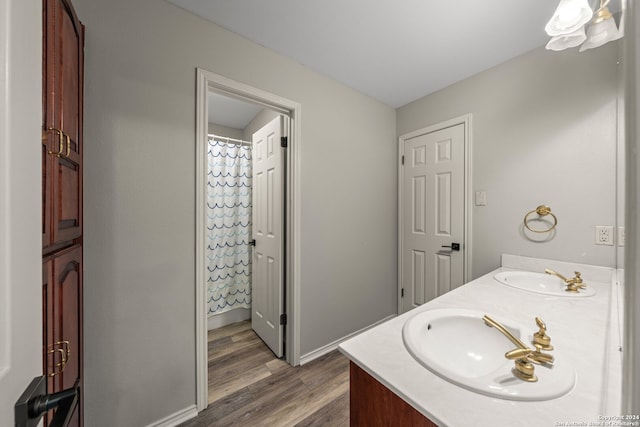 bathroom featuring vanity, curtained shower, and wood-type flooring